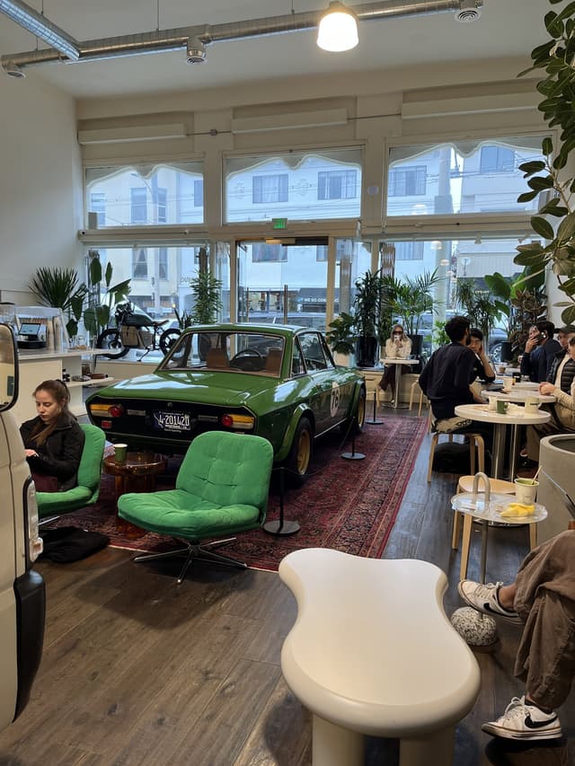 Motoring Coffee in San Francisco — a green Lancia Fulvia parked inside the café
